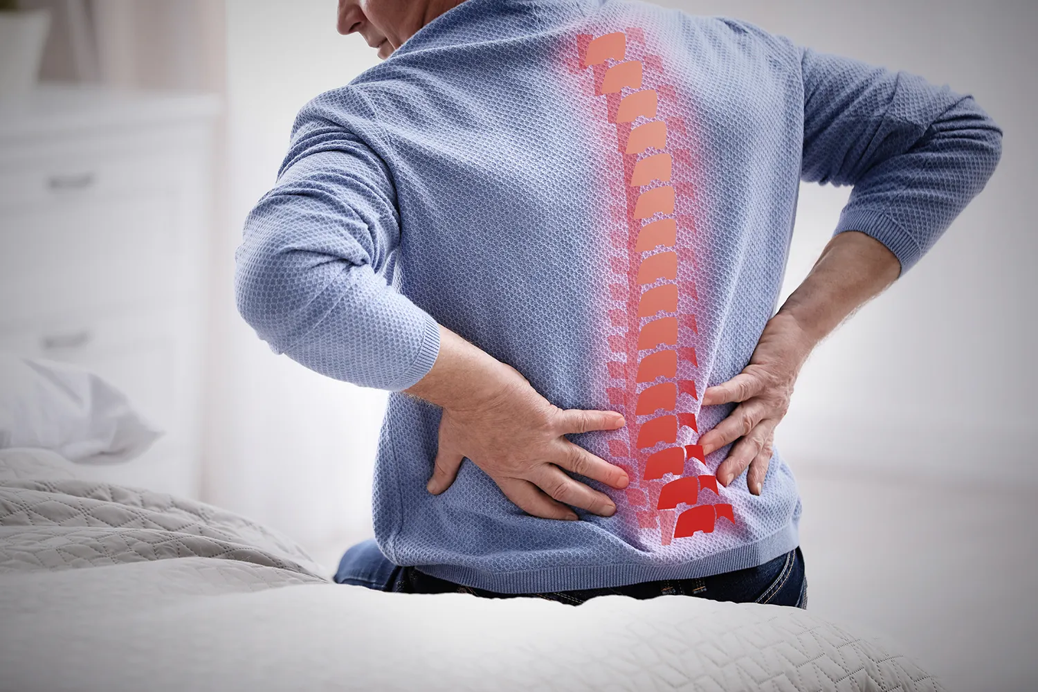 man holding his back due to sciatica pain