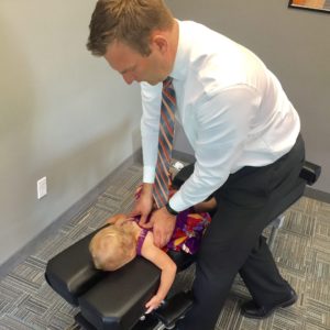 Dr. Peter Lynch giving kid pediatric care treatment